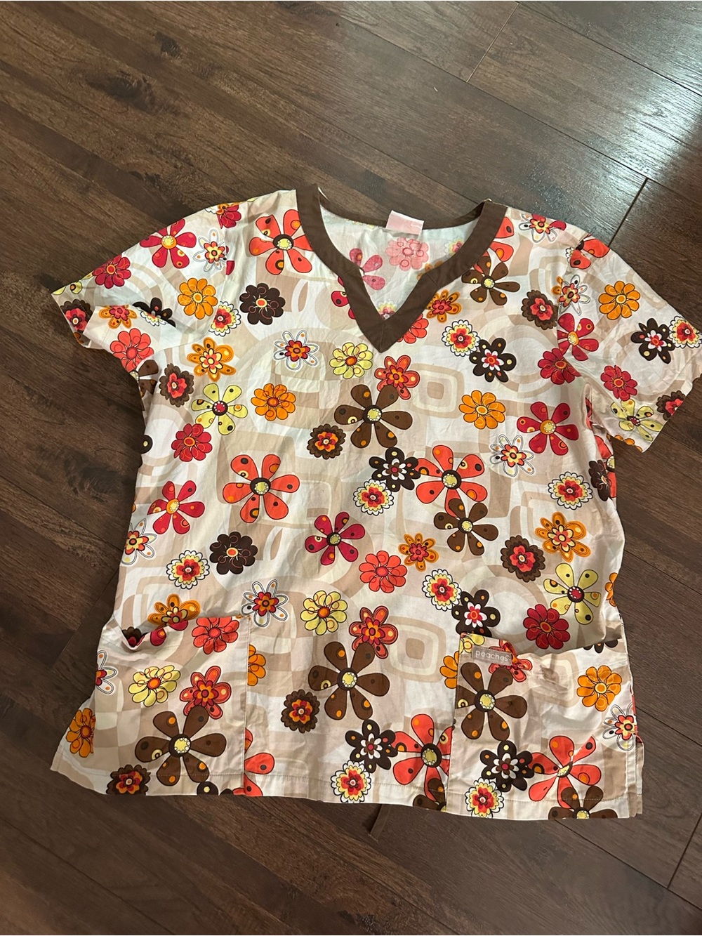 Peaches Uniforms Floral Print V-Neck Scrub Top in Orange, Brown, Yellow